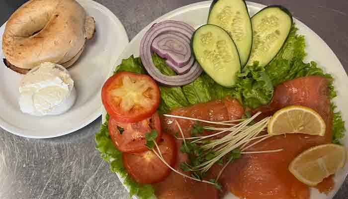 Enjoy a Cafe Catron menu classic: smoked salmon plate with fresh veggies, bagel, and cream cheese.